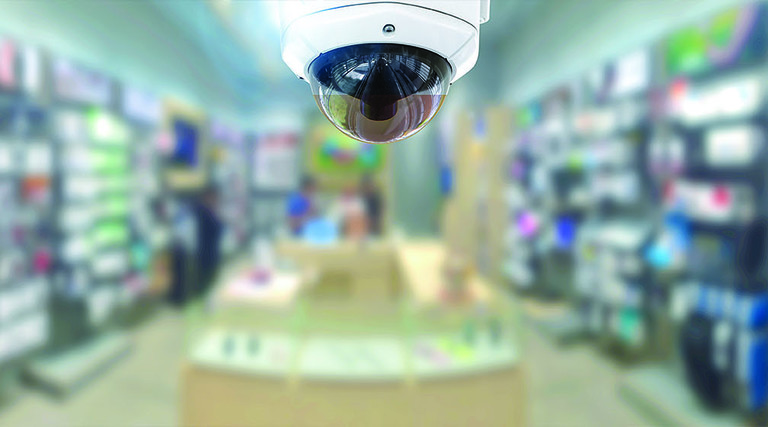 security camera over the aisle of a store