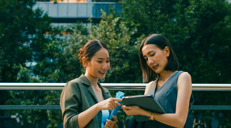 Coworkers collaborate outside of a sustainable office 