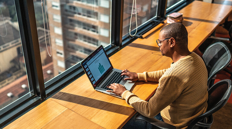 Person working in the office on a laptop