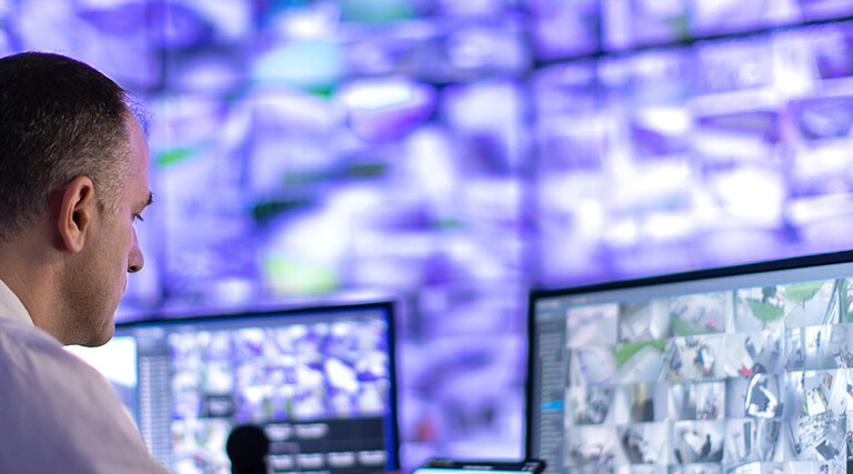 Man working in a security surveillance station