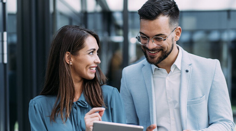 Business people using digital tablet outdoors