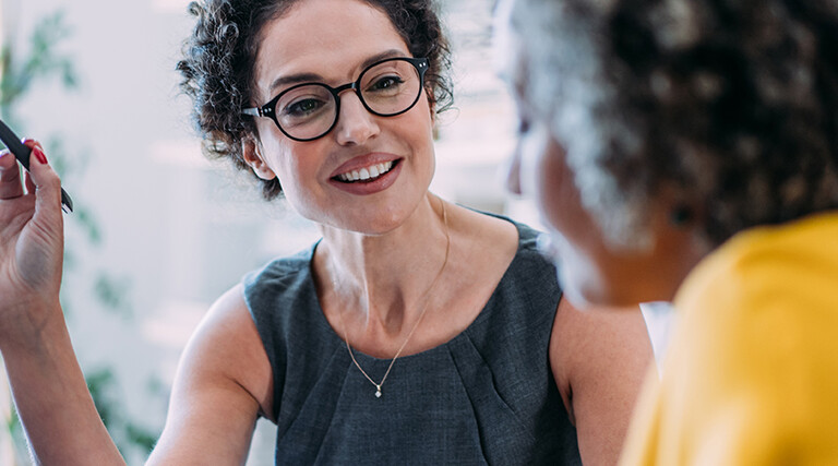 Two females talking in an office