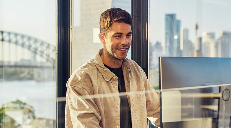 IT leader working on a large monitor display