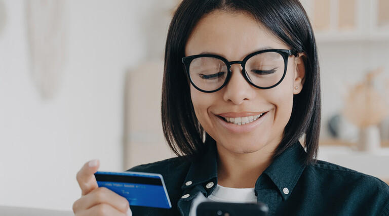 Person paying with card and a phone