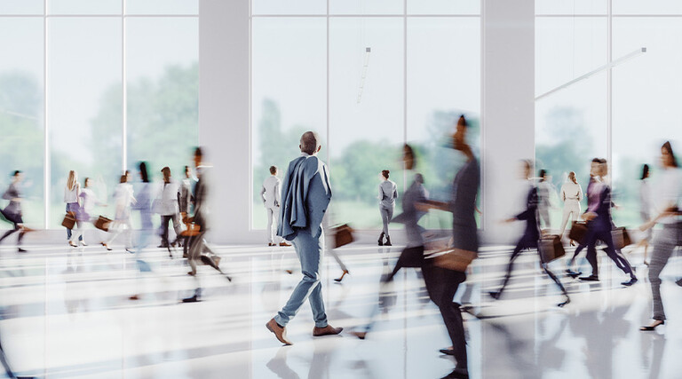 Business people walking through office building