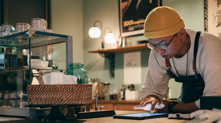 Cafe owner using technology