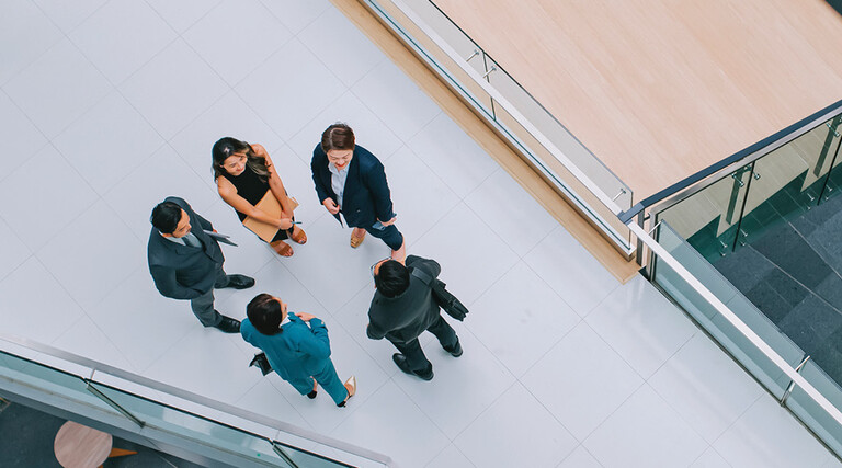 Business leaders gathered in a hallway
