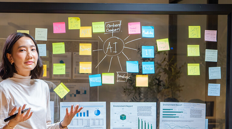 Biz Woman talking at a board with AI & charts