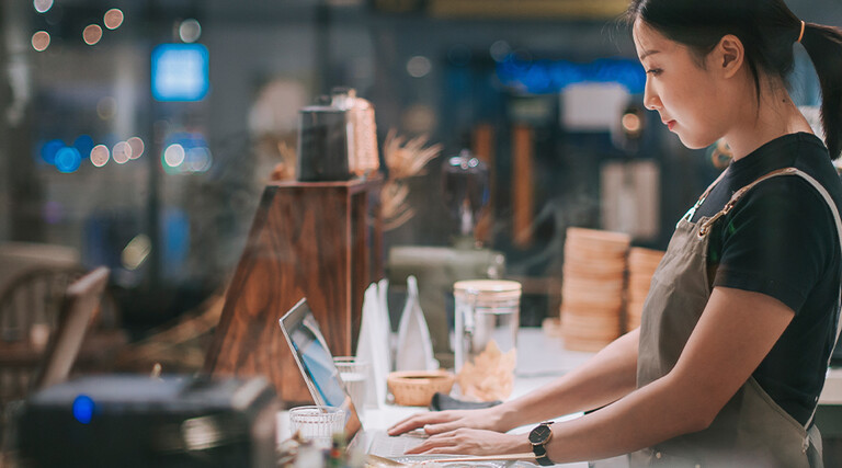 lady at counter on laptop