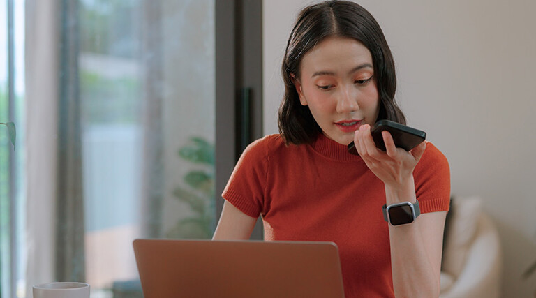 Person using phone and computer