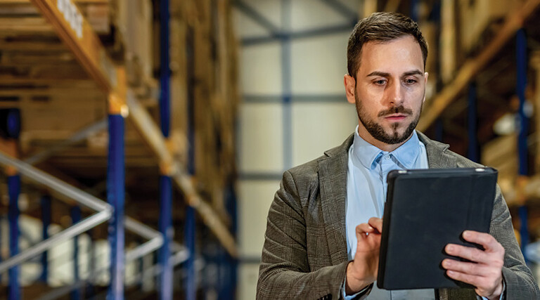 man on tablet in warehouse