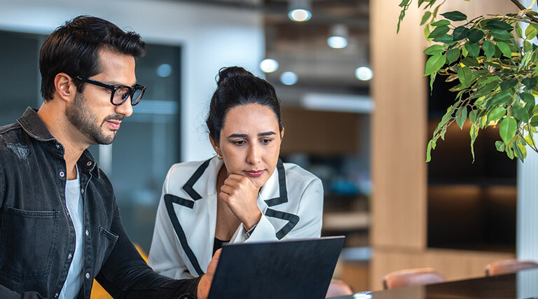 two small business owners on a laptop
