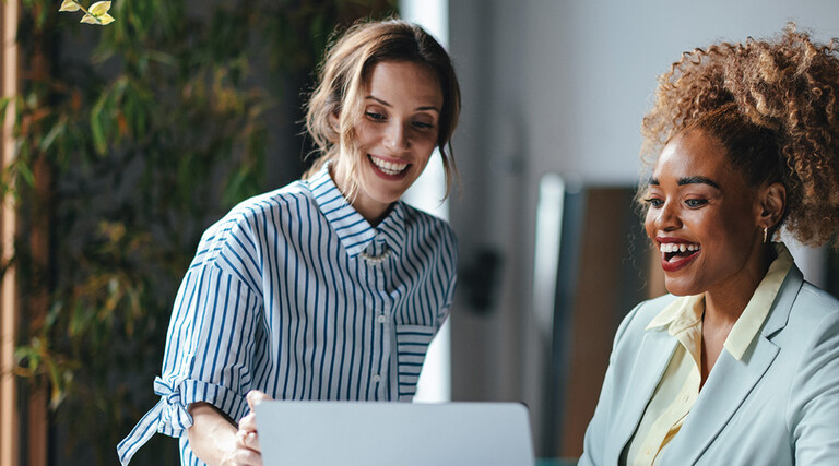 Two businesswomen viewing a laptop 