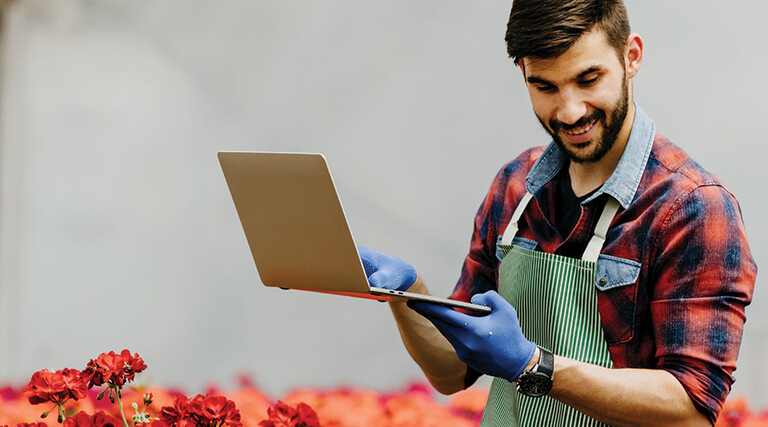 botanist uses laptop in the field