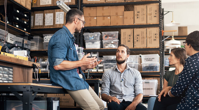 A group of colleagues having a discussion in a workshop