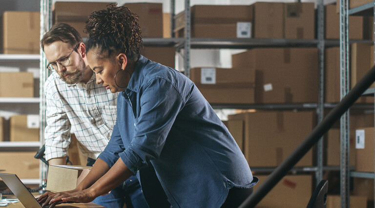 Two business owners in a warehouse
