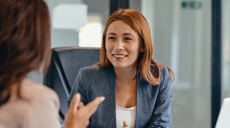 Three professionals in a discussion at an office meeting