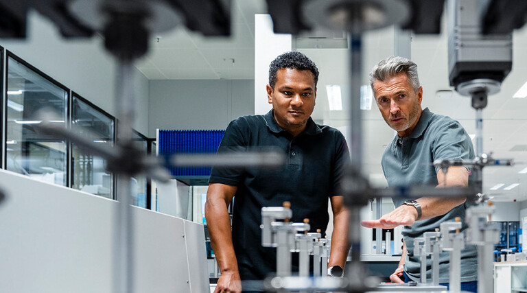 Coworkers discussing manufacturing