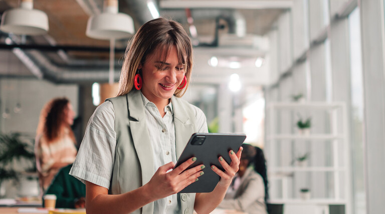 Businesswoman using tablet in modern office