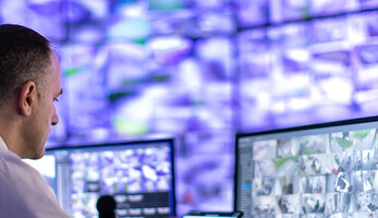 Man working in a security surveillance station