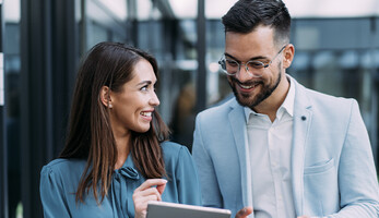 Business people using digital tablet outdoors