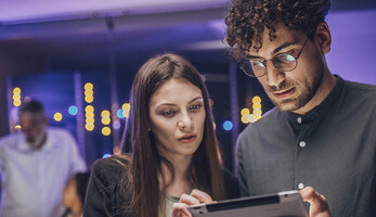Coworkers reviewing tablet