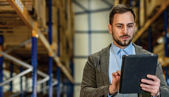 man on tablet in warehouse