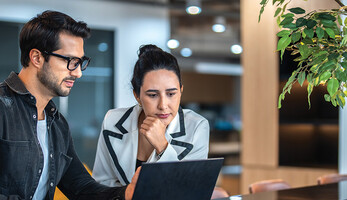 two small business owners on a laptop