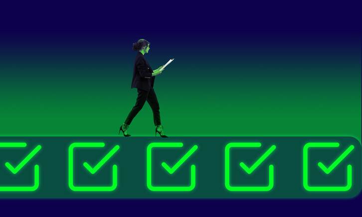 Businessperson walking on neon colored icons