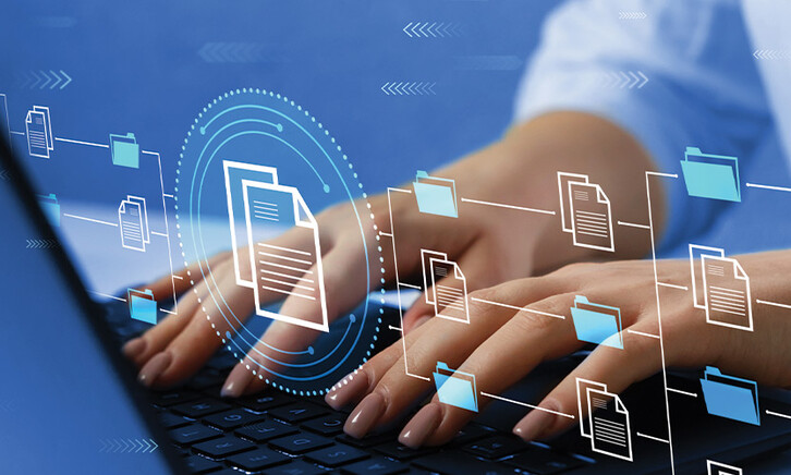 woman's hands typing on laptop