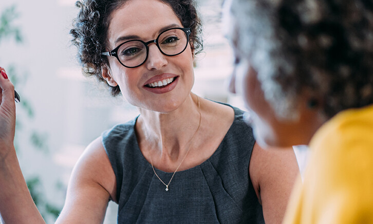 Two females talking in an office
