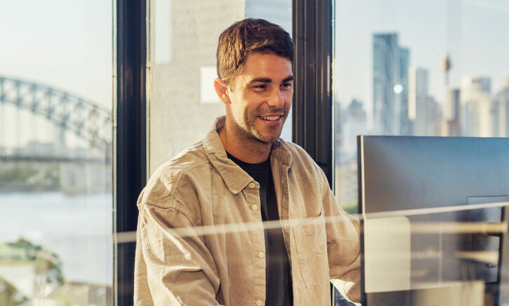IT leader working on a large monitor display