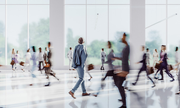 Business people walking through office building