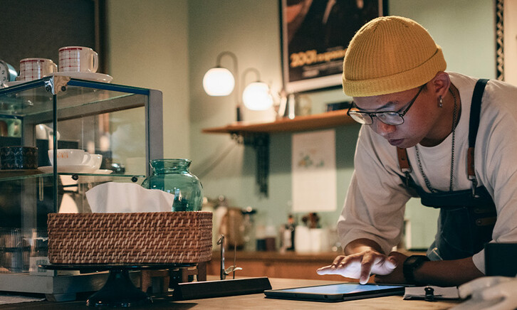 Cafe owner using technology