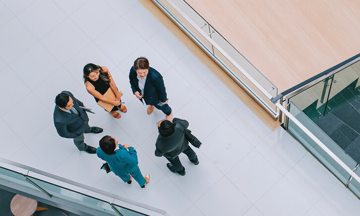 Business leaders gathered in a hallway