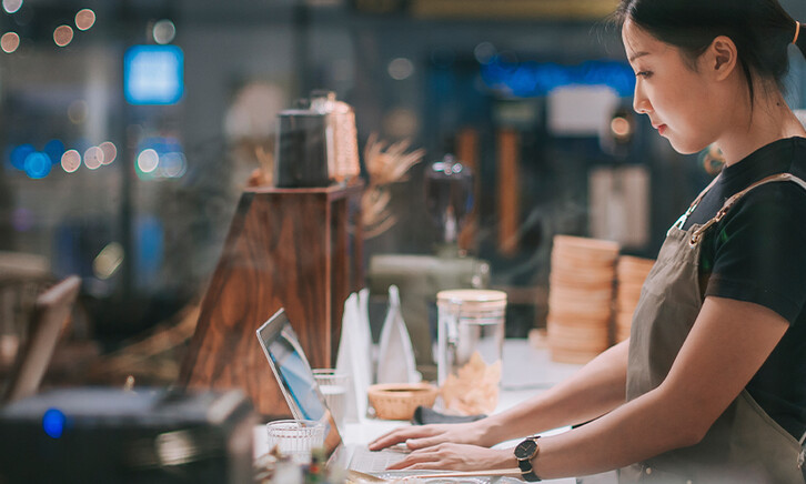 lady at counter on laptop