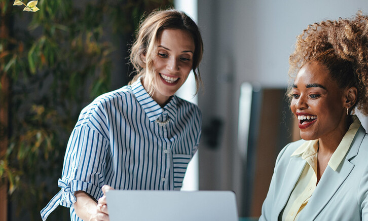 Two businesswomen viewing a laptop 