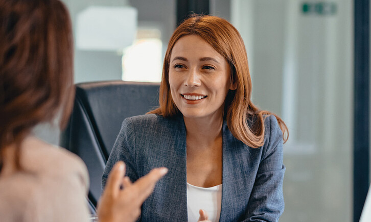 Three professionals in a discussion at an office meeting