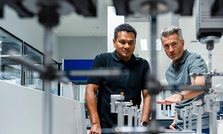 Coworkers discussing manufacturing