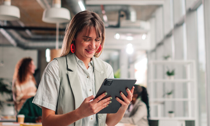 Businesswoman using tablet in modern office