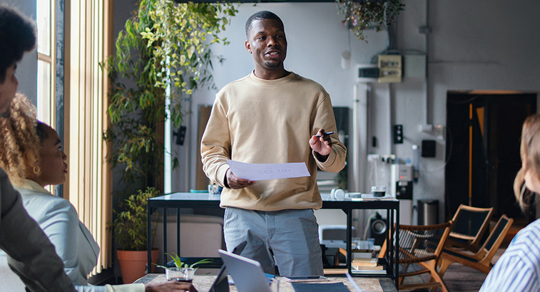 Man talking to 2 people from notes