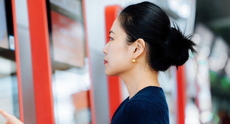 Person using touchscreen kiosk