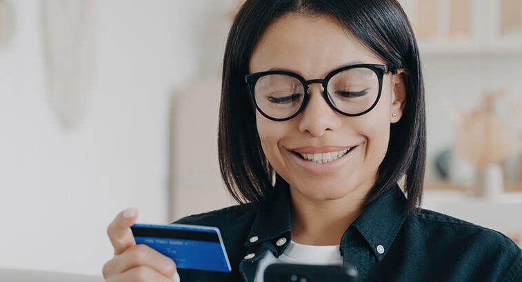 Person paying with card and a phone