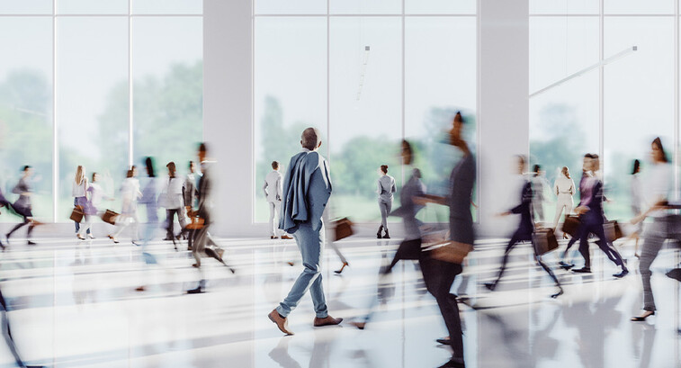 Business people walking through office building
