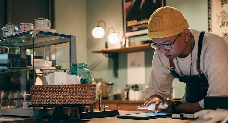 Cafe owner using technology