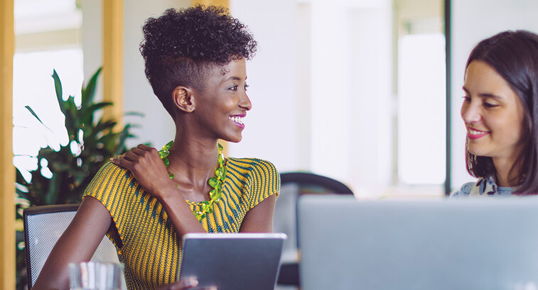 small business owners smile around computer