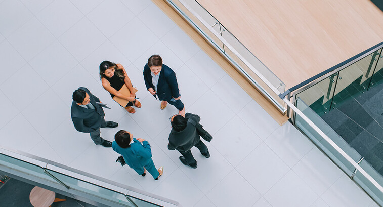 Business leaders gathered in a hallway