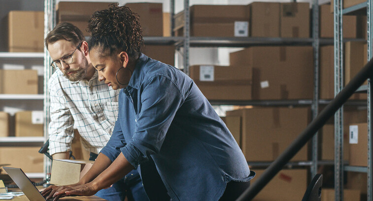 Two business owners in a warehouse