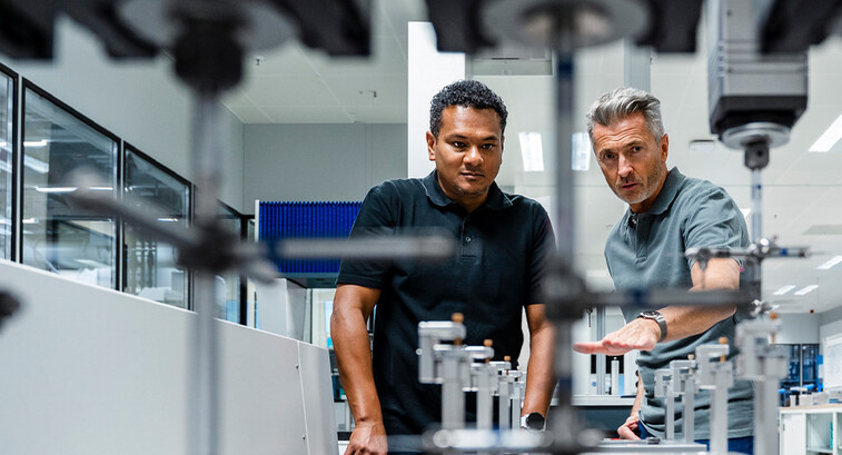 Coworkers discussing manufacturing