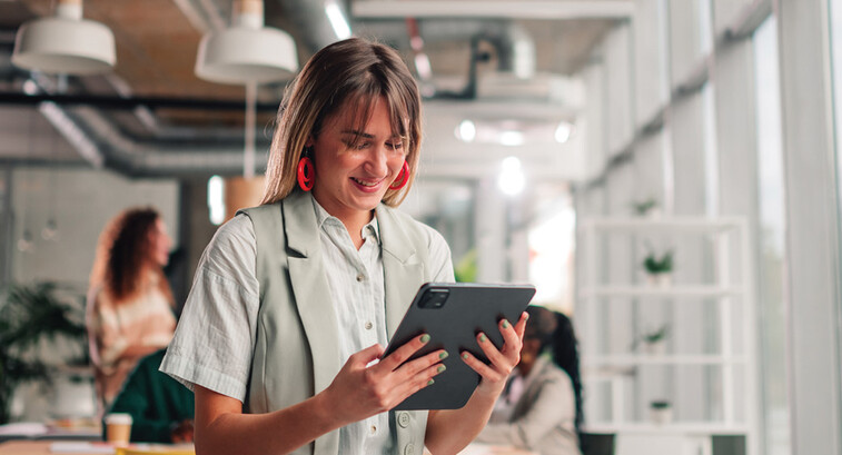 Businesswoman using tablet in modern office